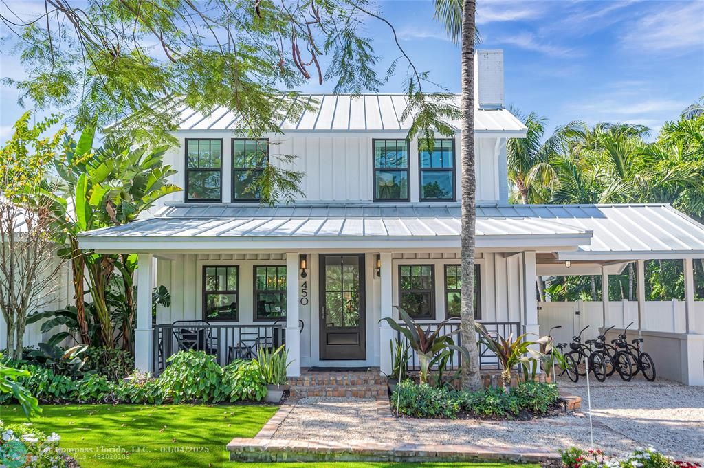 450 North Swinton Avenue Delray Beach, FL 33444 - Photo 40 of 43 a front view of a house with garden and porch