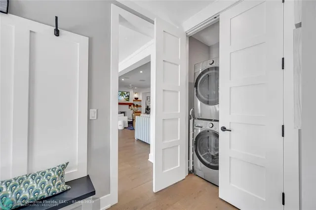 a green field with lots of trees in front of it