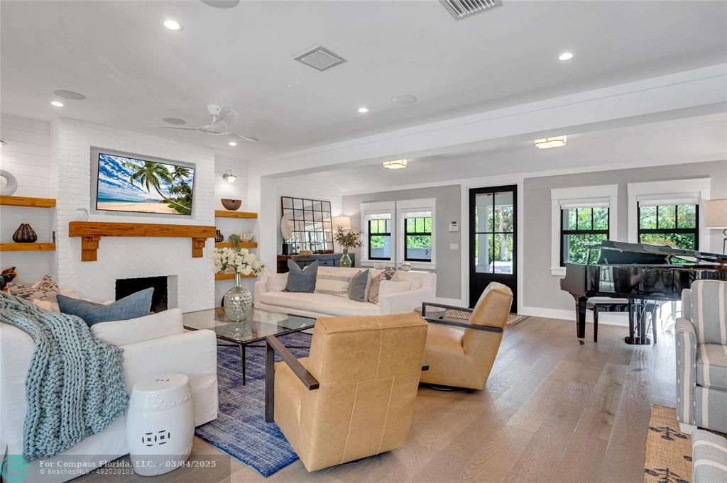 450 North Swinton Avenue Delray Beach, FL 33444 - Photo 8 of 43 a living room with furniture a fireplace and a table