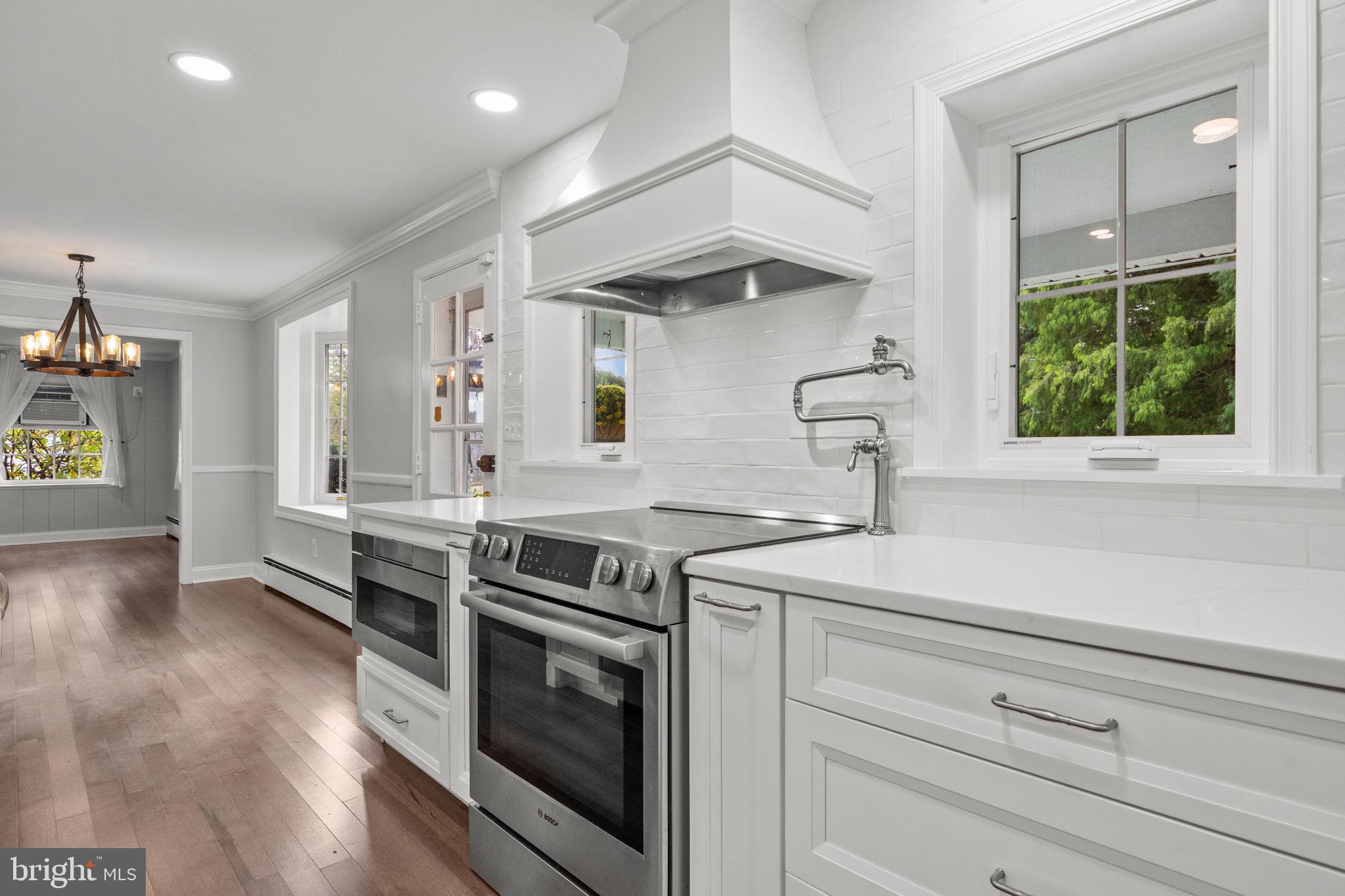1434 Holcomb Road Huntingdon Valley, PA 19006 - Photo 16 of 49 a kitchen with a stove and a wooden floor