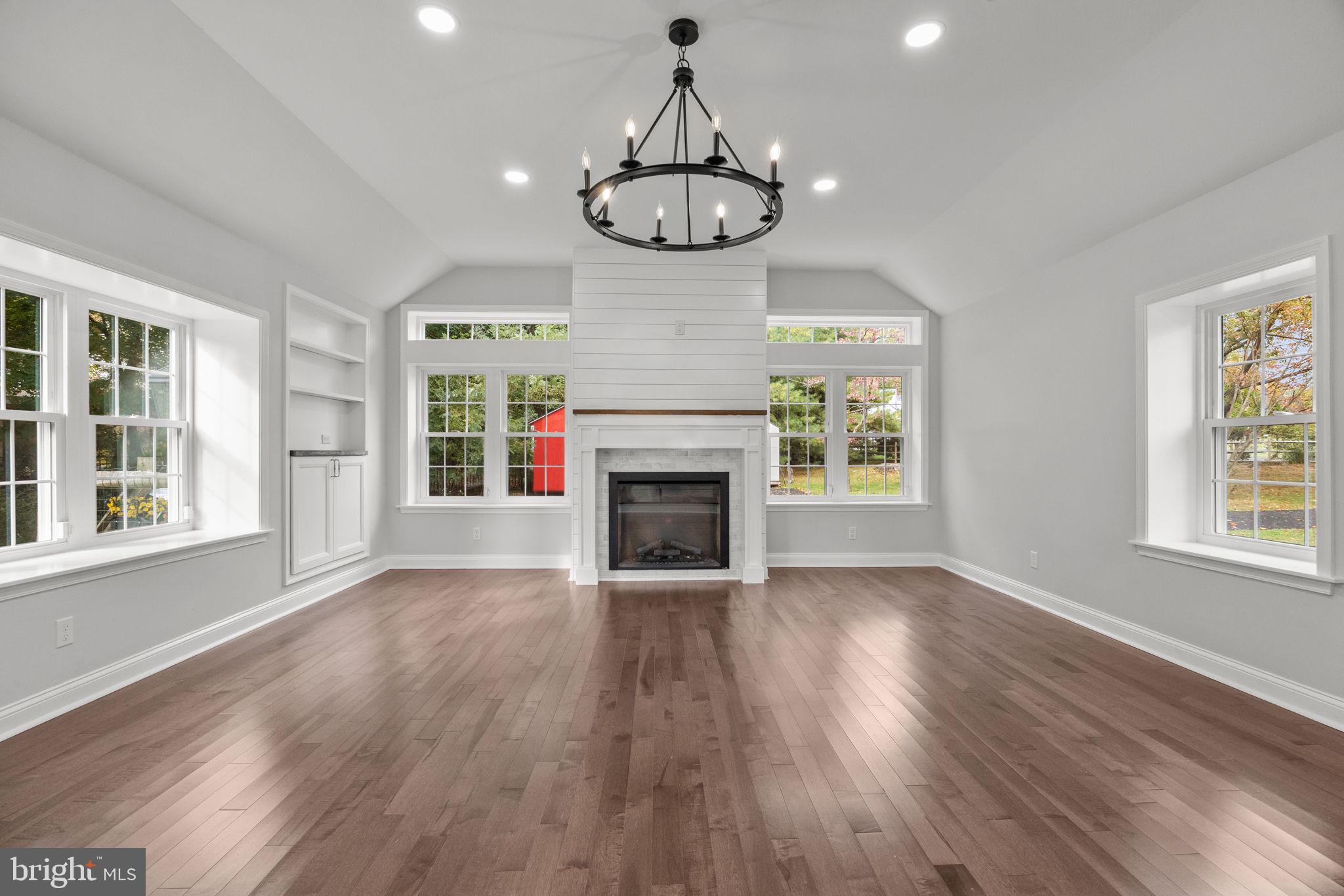 1434 Holcomb Road Huntingdon Valley, PA 19006 - Photo 22 of 49 a view of an empty room with wooden floor fireplace and a window