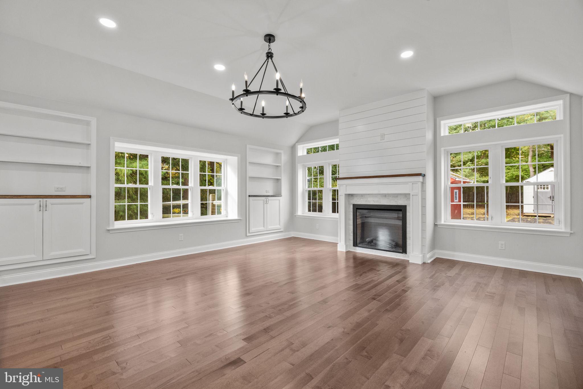 1434 Holcomb Road Huntingdon Valley, PA 19006 - Photo 23 of 49 a view of an empty room with wooden floor fireplace and a window