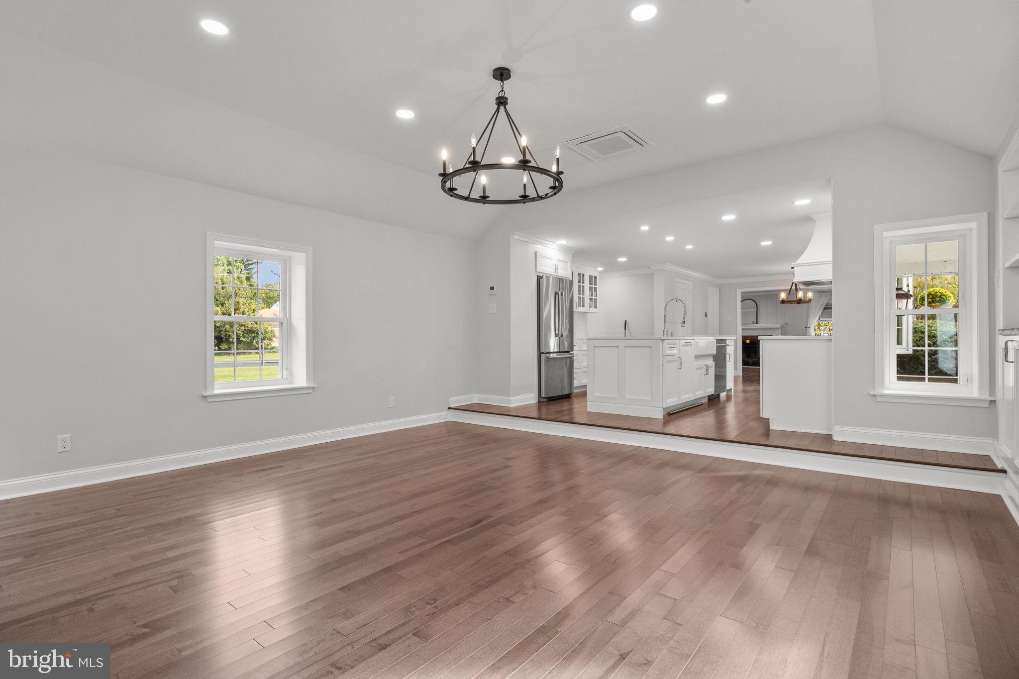 1434 Holcomb Road Huntingdon Valley, PA 19006 - Photo 24 of 49 an empty room with wooden floor large windows and a ceiling fan
