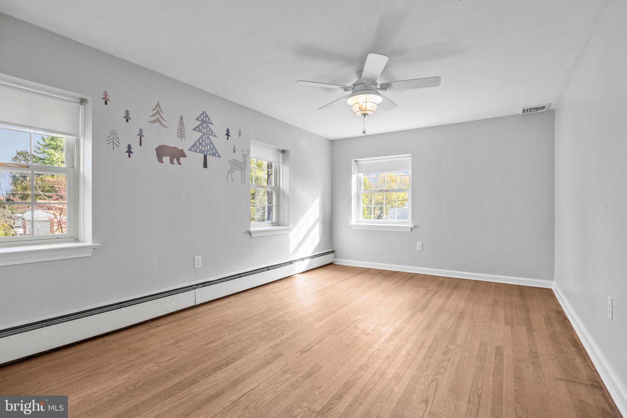 1434 Holcomb Road Huntingdon Valley, PA 19006 - Photo 36 of 49 a view of an empty room with window and wooden floor