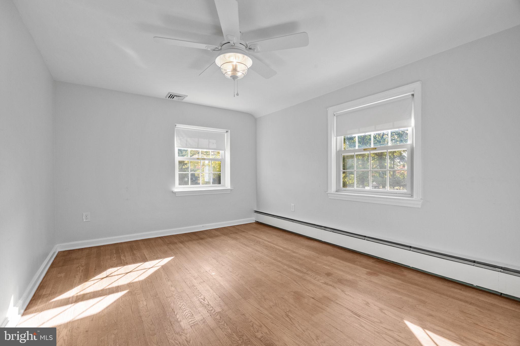1434 Holcomb Road Huntingdon Valley, PA 19006 - Photo 37 of 49 wooden floor in an empty room with a window