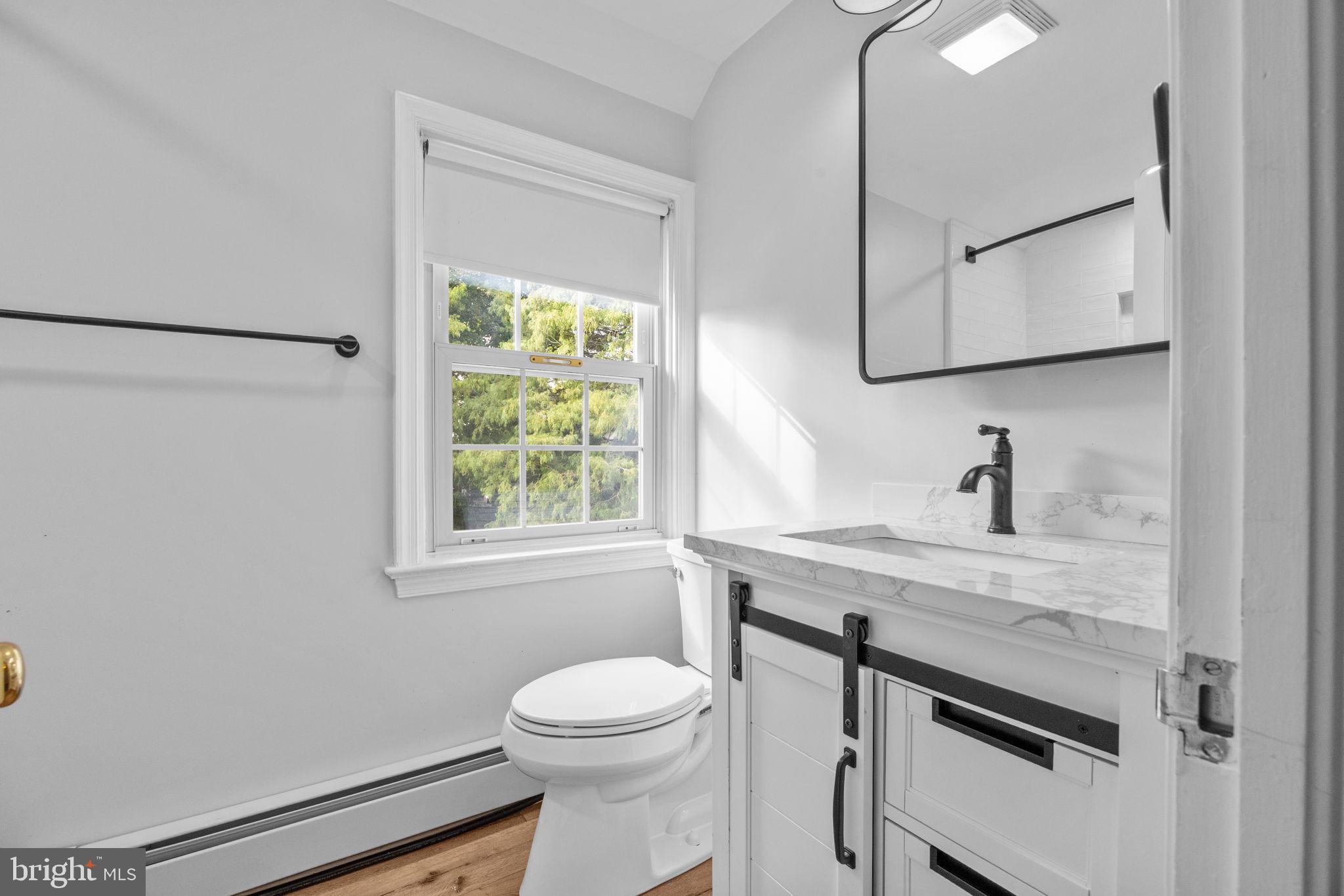 1434 Holcomb Road Huntingdon Valley, PA 19006 - Photo 38 of 49 a bathroom with a granite countertop sink a toilet and a mirror