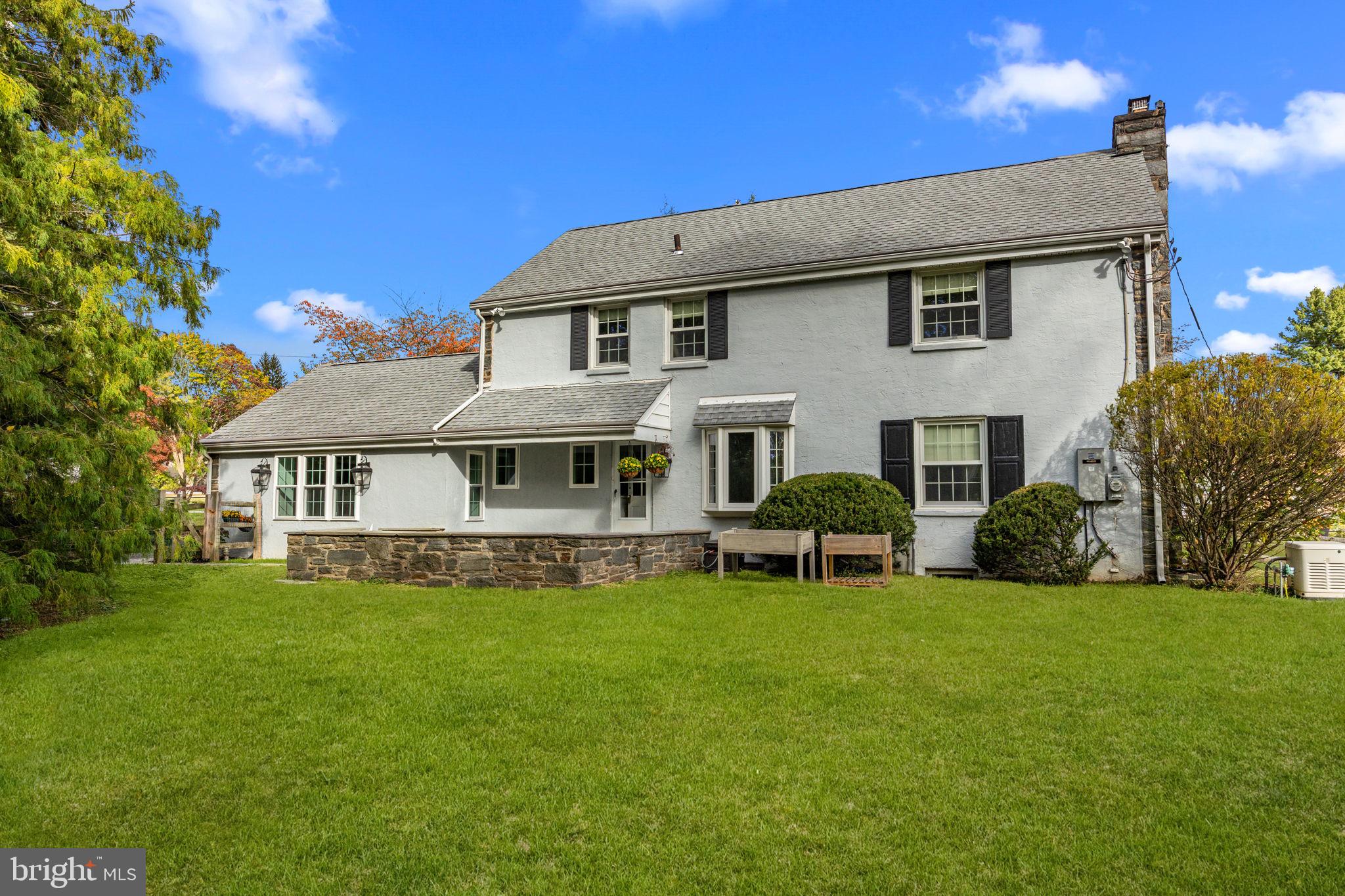 1434 Holcomb Road Huntingdon Valley, PA 19006 - Photo 48 of 49 a big white house with a big yard and potted plants