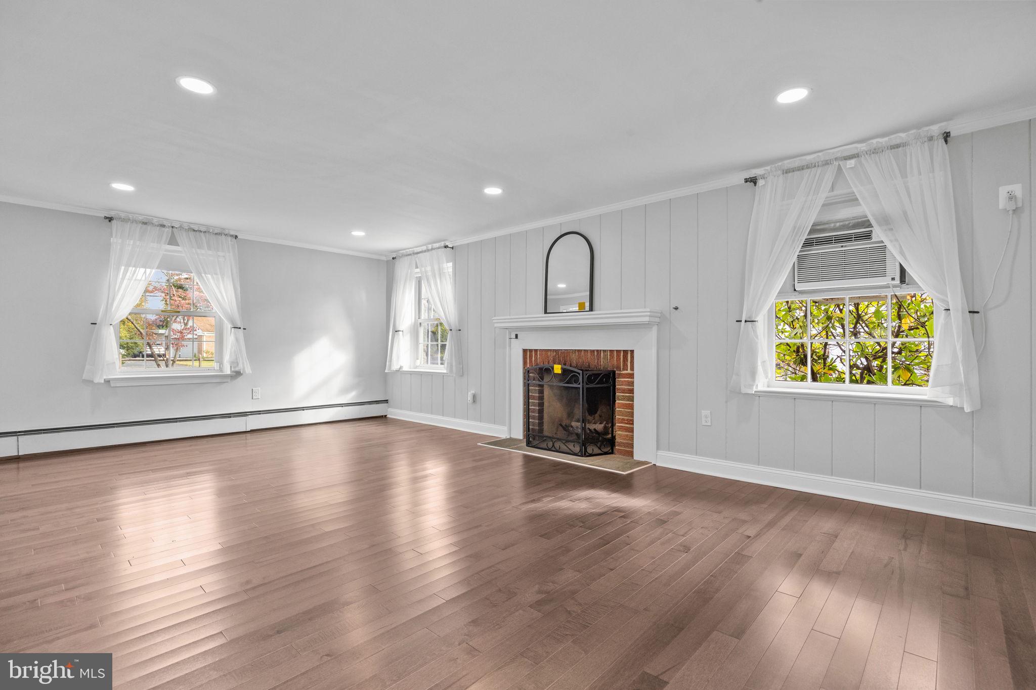 1434 Holcomb Road Huntingdon Valley, PA 19006 - Photo 9 of 49 an empty room with windows and fireplace