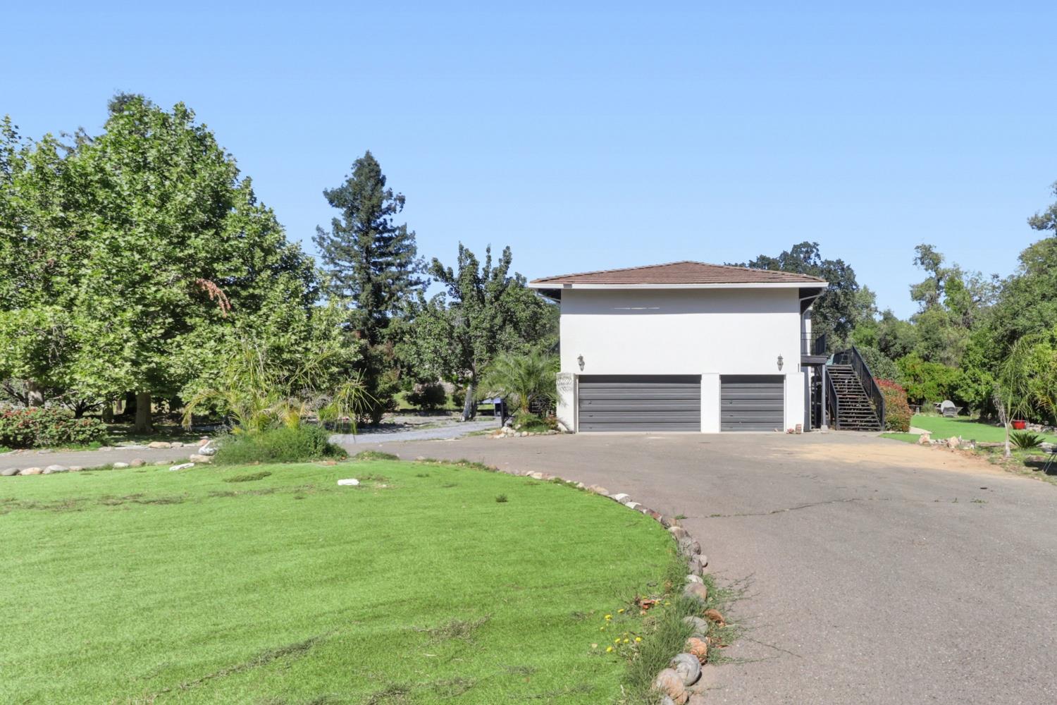 4330 Cavitt Stallman Road Granite Bay, CA 95746 - Photo 74 of 85 a front view of a house with a yard and garage