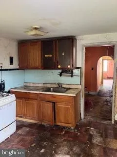 a kitchen with granite countertop a sink and a stove