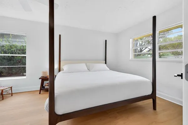 a bedroom with a bed and a window