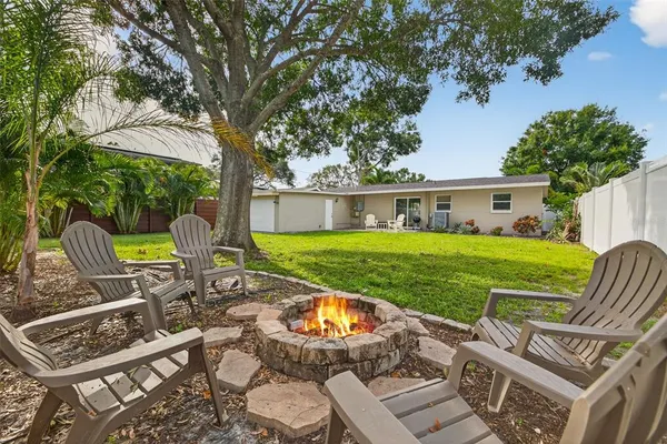 a view of a house with backyard porch and sitting area