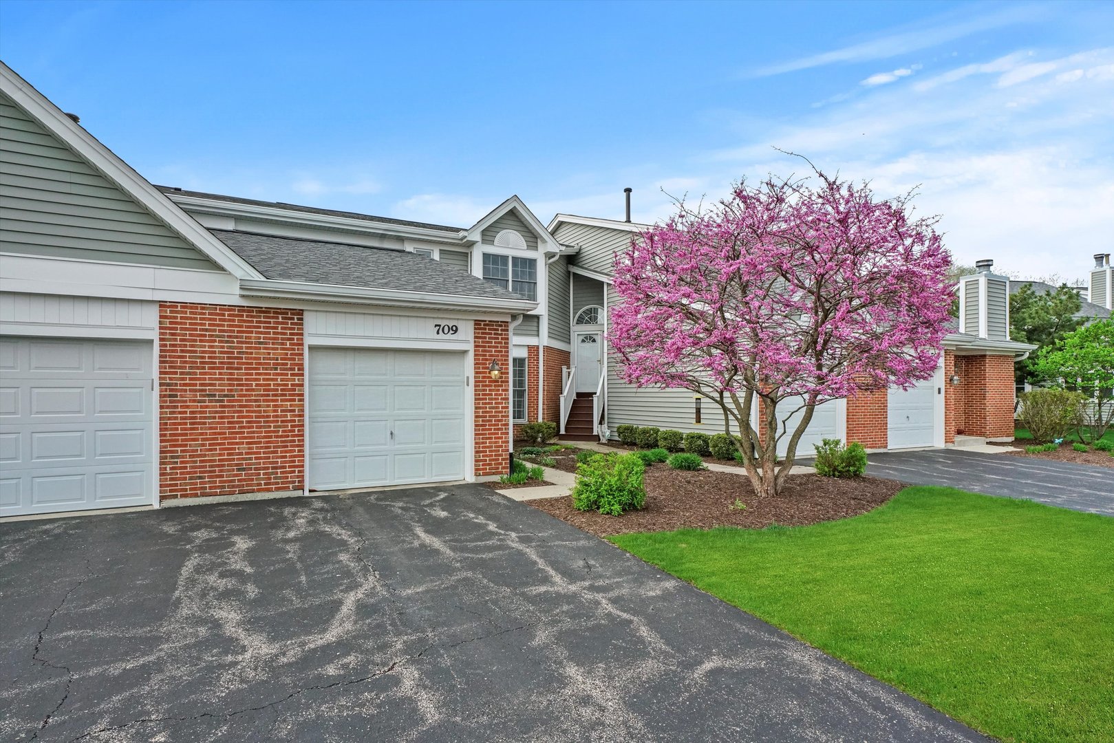 709 Daybreak Lane Carol Stream, IL 60188 - Photo 28 of 30 a front view of a house with a yard and garage