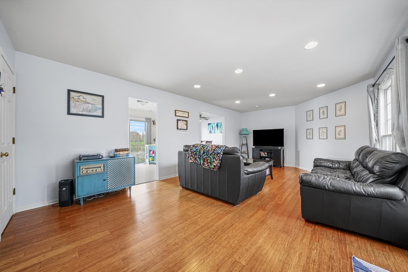 709 Daybreak Lane Carol Stream, IL 60188 - Photo 3 of 30 a living room with furniture and a flat screen tv