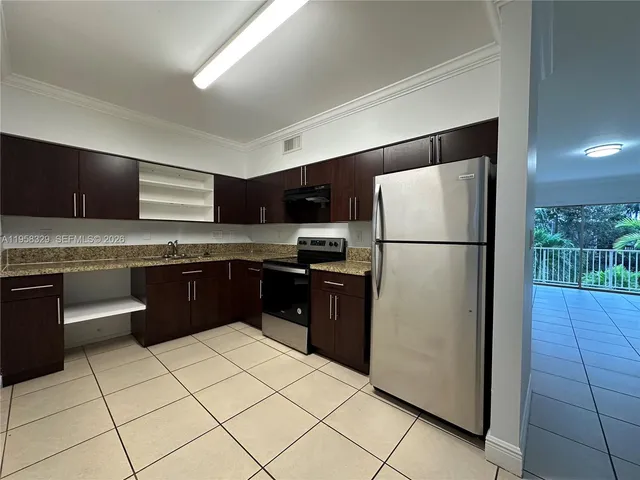 a kitchen with stainless steel appliances granite countertop a refrigerator sink and stove