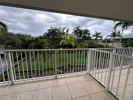 a view of a balcony with wooden fence and floor