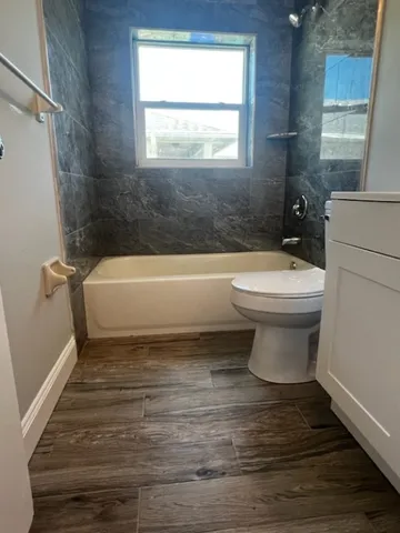 a bathroom with a sink a toilet and bathtub
