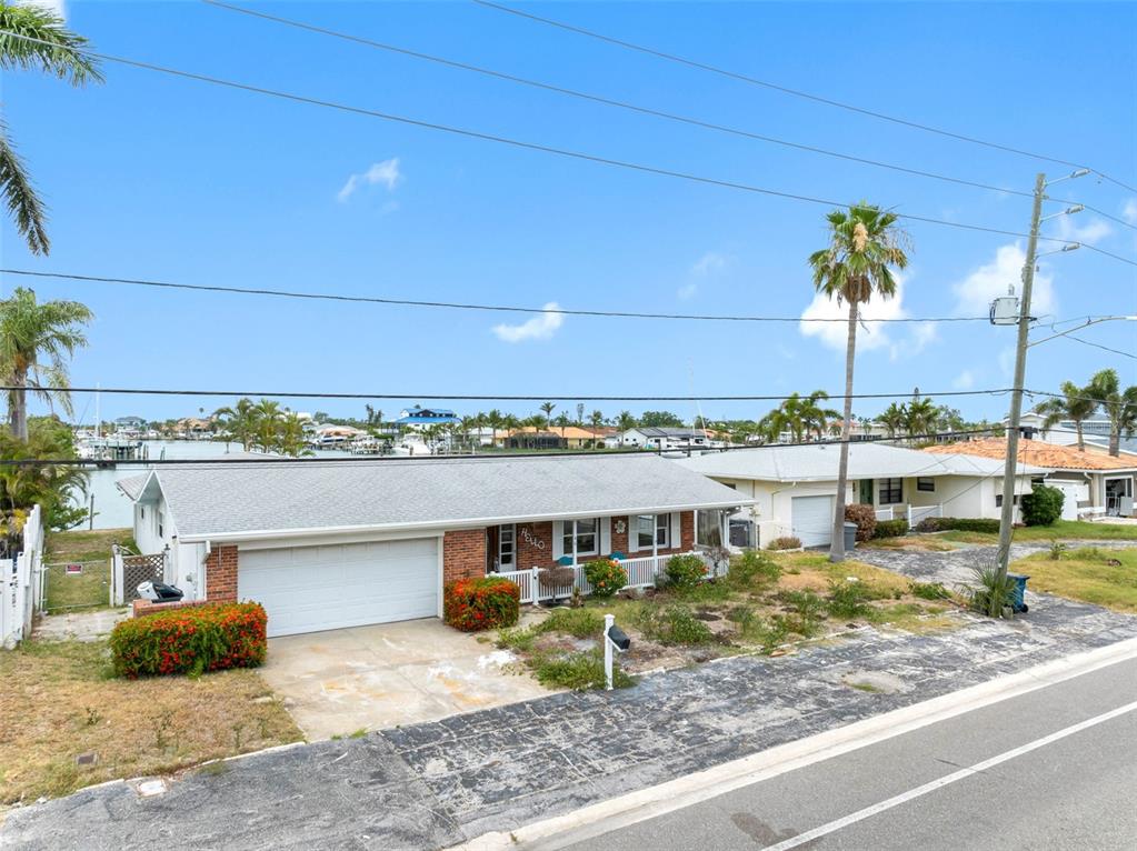 440 115th Avenue Treasure Island, FL 33706 - Photo 2 of 25 a view of a water with a couple of people sitting on roof