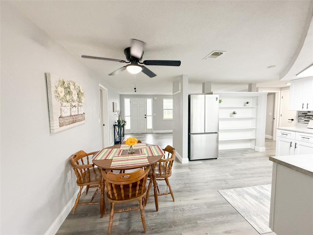 10805 Fillmore Avenue Port Richey, FL 34668 - Photo 13 of 32 a dining room with furniture and window