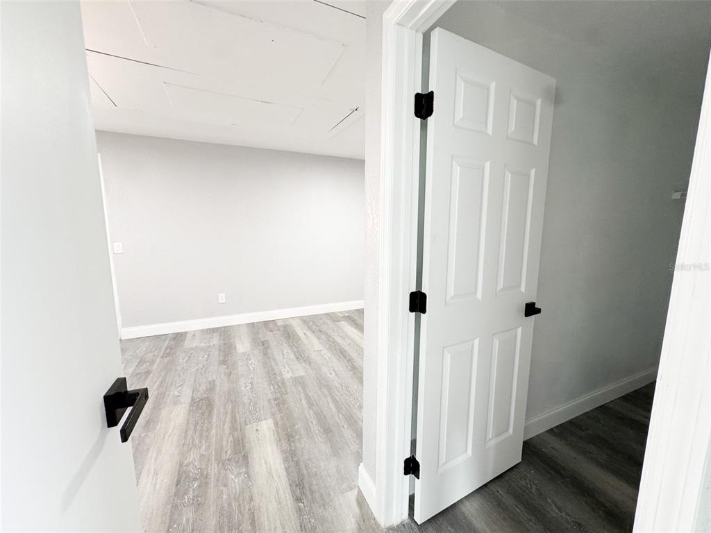 10805 Fillmore Avenue Port Richey, FL 34668 - Photo 18 of 32 a view of a hallway with wooden floor and staircase