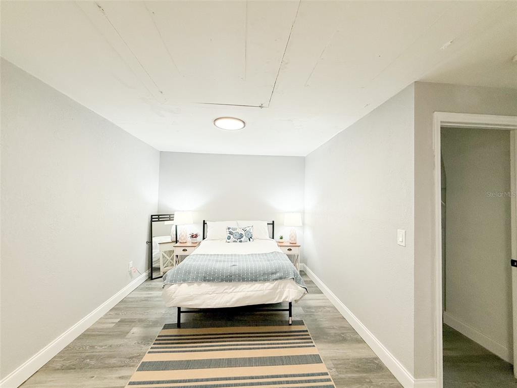 10805 Fillmore Avenue Port Richey, FL 34668 - Photo 19 of 32 a bedroom with a bed and a mirror