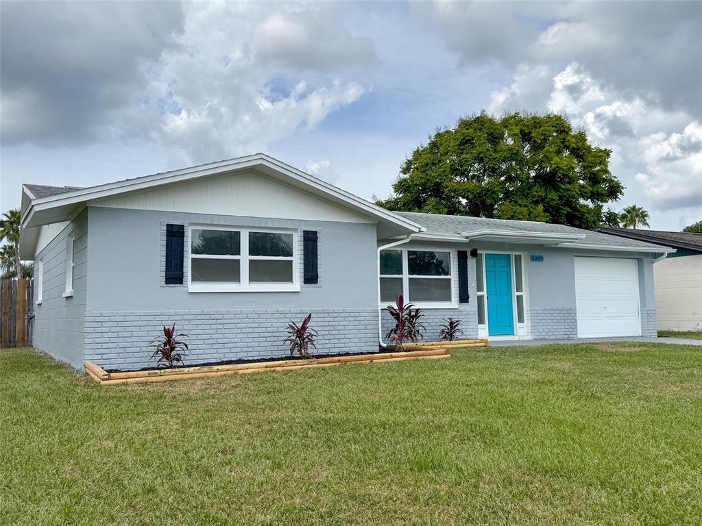 10805 Fillmore Avenue Port Richey, FL 34668 - Photo 2 of 32 a front view of house with yard and outdoor seating