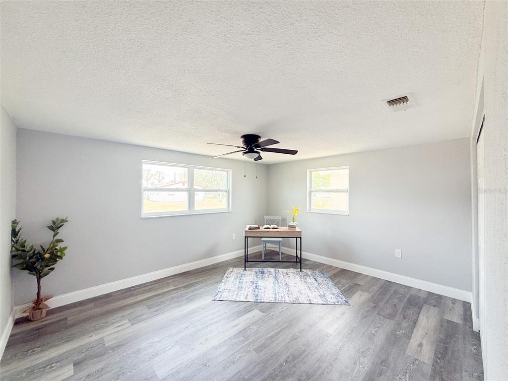 10805 Fillmore Avenue Port Richey, FL 34668 - Photo 25 of 32 wooden floor in an empty room with a window