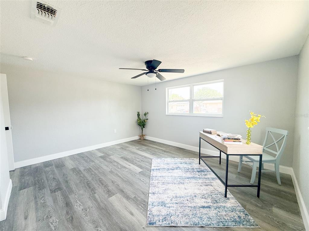 10805 Fillmore Avenue Port Richey, FL 34668 - Photo 26 of 32 a workspace with wooden floor and a window
