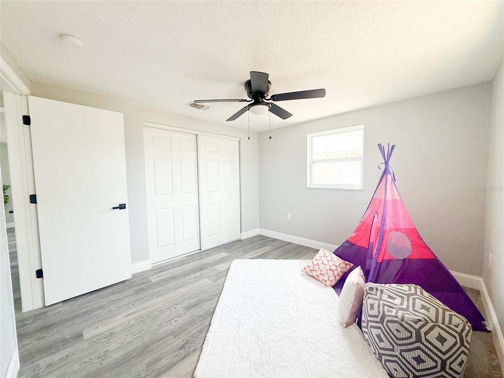 10805 Fillmore Avenue Port Richey, FL 34668 - Photo 28 of 32 a bedroom with a bed and a window