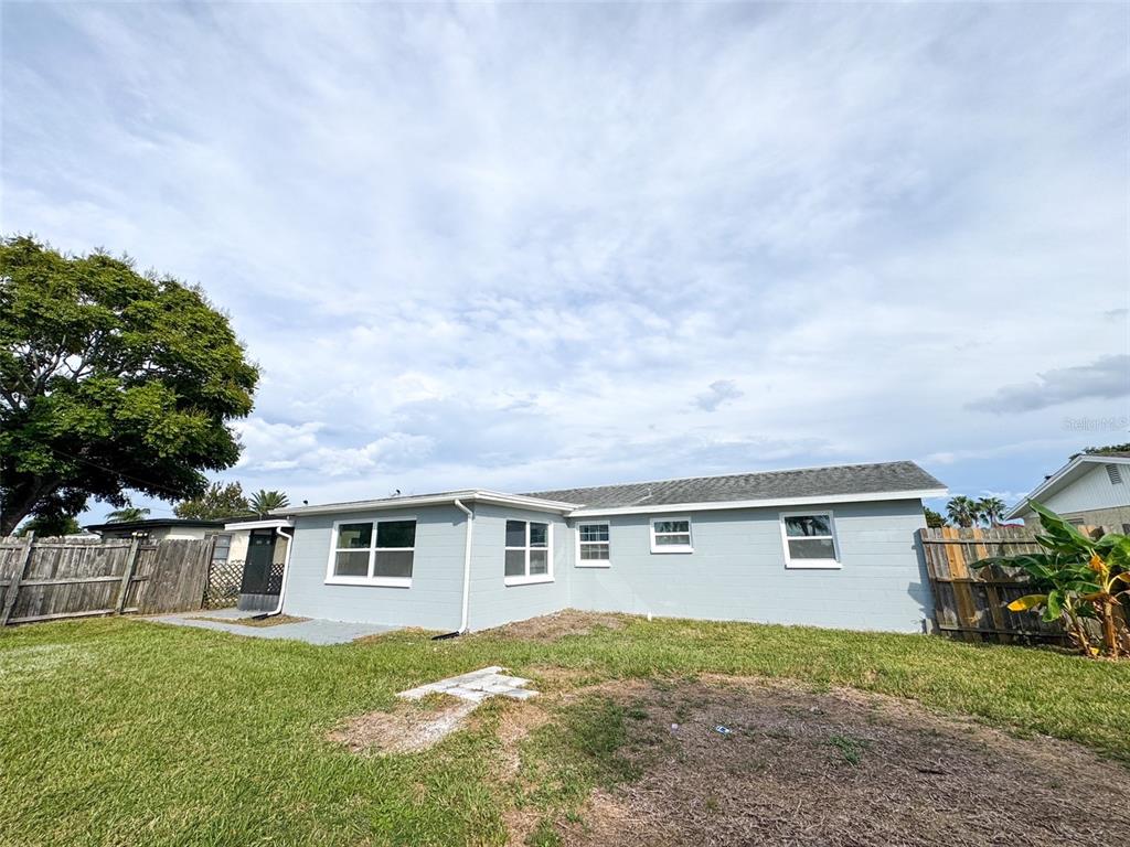 10805 Fillmore Avenue Port Richey, FL 34668 - Photo 31 of 32 a front view of a house with a yard