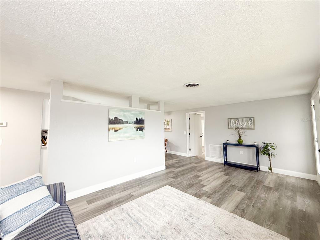 10805 Fillmore Avenue Port Richey, FL 34668 - Photo 5 of 32 a living room with furniture and a wooden floor