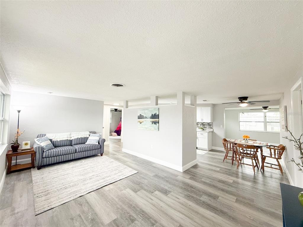 10805 Fillmore Avenue Port Richey, FL 34668 - Photo 6 of 32 a living room with furniture and a wooden floor