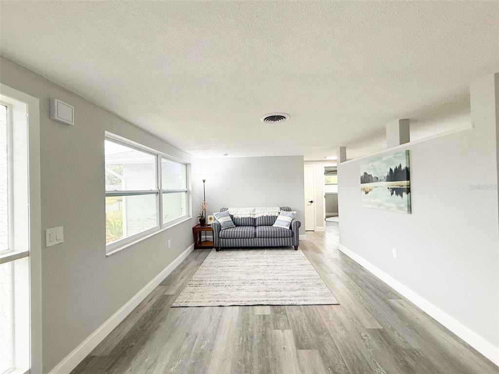 10805 Fillmore Avenue Port Richey, FL 34668 - Photo 7 of 32 a living room with furniture and a large window
