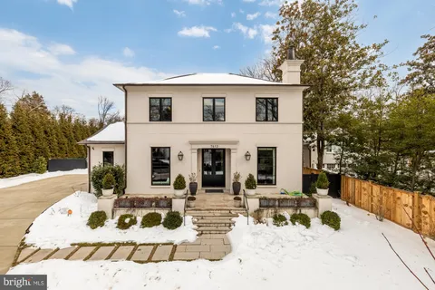 a view of a white house with a yard