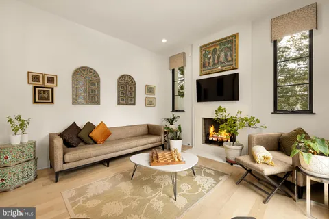 a kitchen with stainless steel appliances a white stove top oven a sink and dishwasher