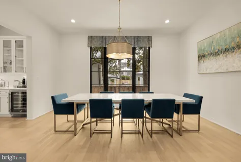 a kitchen with stainless steel appliances cabinets and a wooden floor