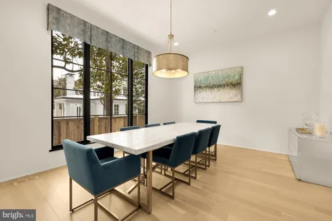 a kitchen with stainless steel appliances white cabinets and a refrigerator
