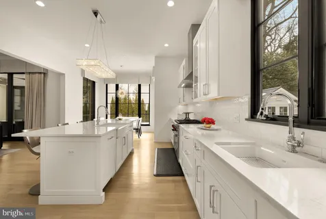 a kitchen with a sink microwave and cabinets