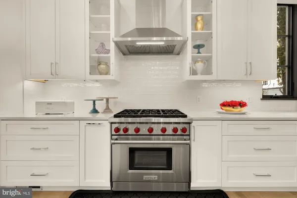 a living room with a couch a flat screen tv and a large window