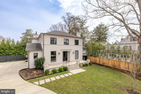 a front view of a house with a yard table and chairs