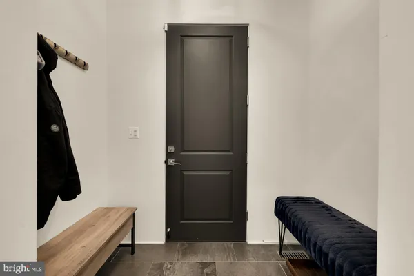 a bathroom with a toilet a sink a mirror and a window