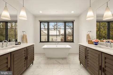 a bedroom with a bed and a dresser with mirror