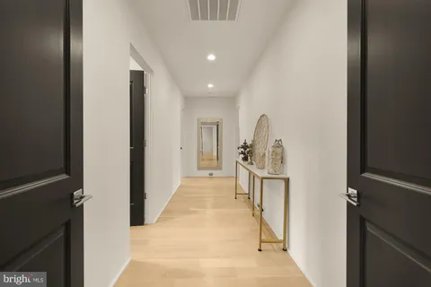 a view of a workspace with furniture and wooden floor