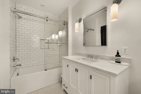 a front view of a house with a yard covered in snow