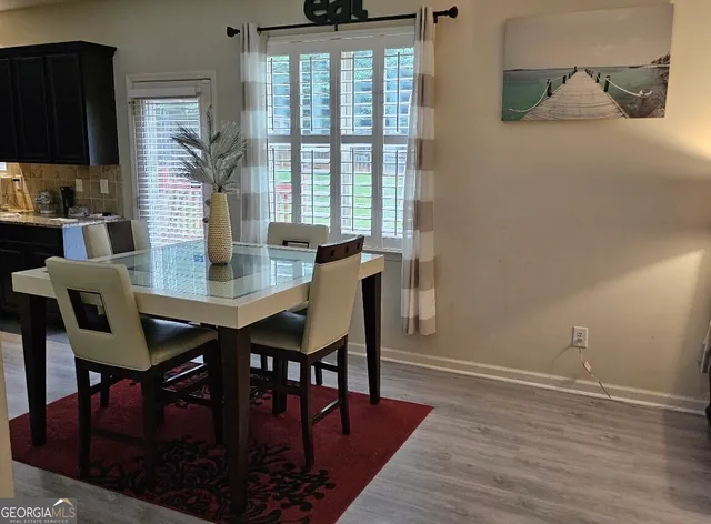 a view of a dining room with furniture and wooden floor
