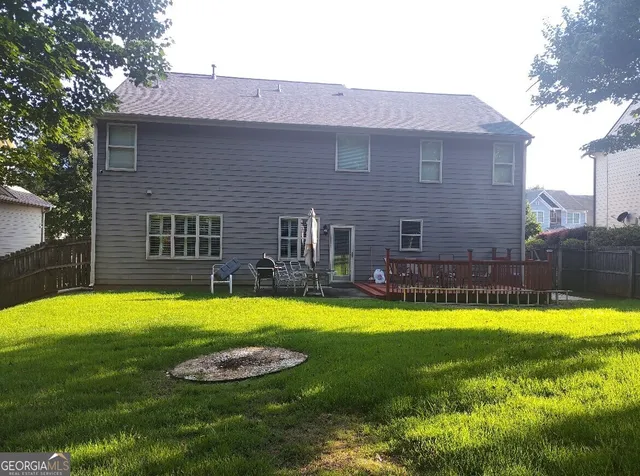 a view of a house with swimming pool and a yard