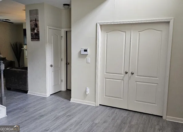 a view of empty room with wooden floor