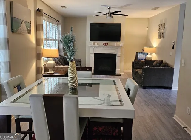 a living room with furniture a flat screen tv and a fireplace