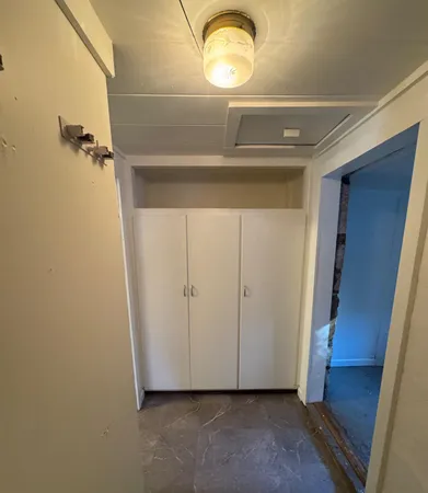 a view of a room with wooden floor