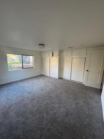 a view of an empty room and a window